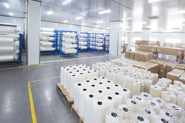 Warehouse with racks and pallets of film rolls
